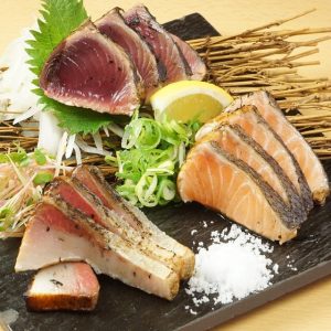 Assorted fresh fish grilled over straw